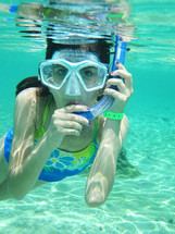 Woman under water with snorkeling gear on