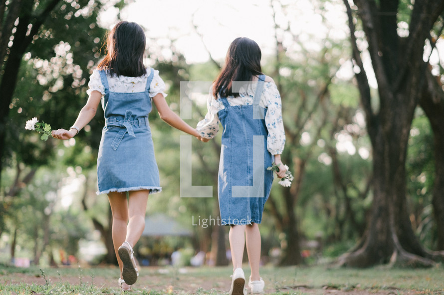 sisters skipping holding hands 