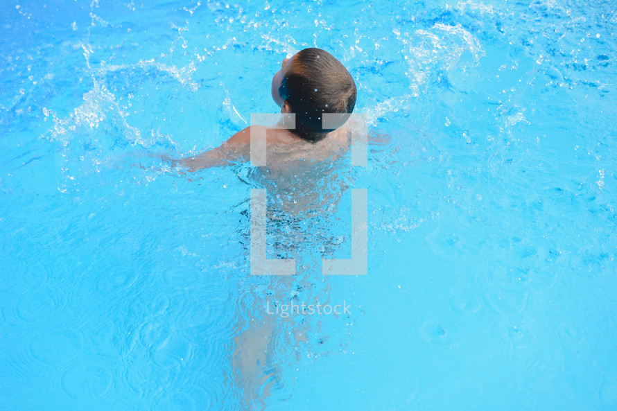 a boy child swimming 