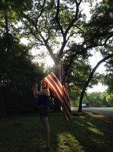 a young woman holding an American flag