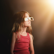 child wearing solar eclipse glasses 