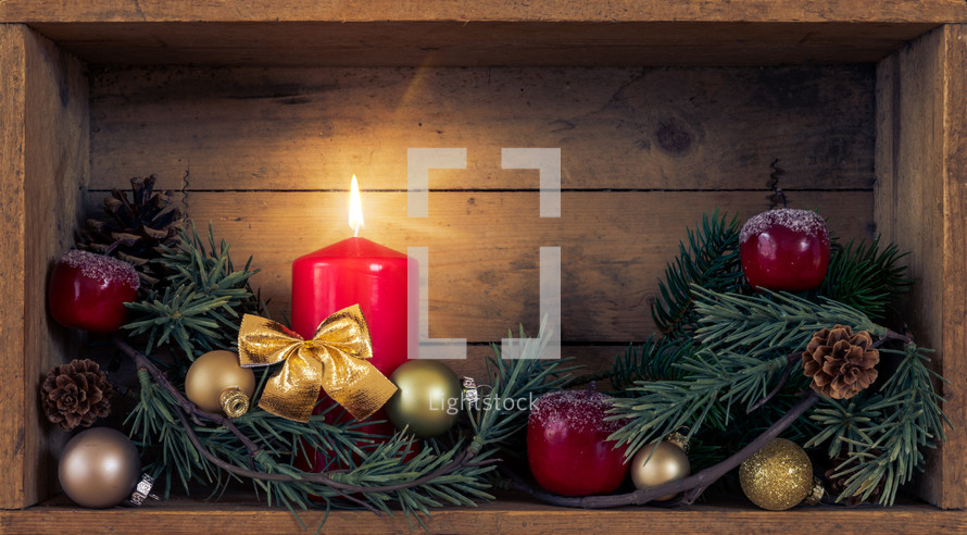 wooden box with greenery and candle at Christmas 