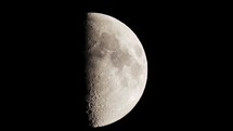 Waxing crescent moon seen with an astronomical telescope in hot summer night. Moon motion and air turbulence visible.