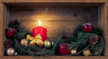 wooden box with greenery and candle at Christmas 