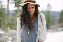 a squinting woman outdoors wearing a hat 