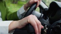 Close up of a woman's hand shifting gears in a manual transmission car.