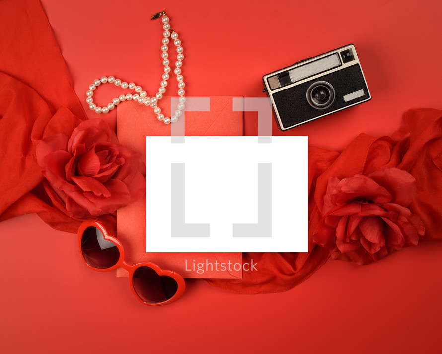 red background, white envelope, hearts, roses, pearls, camera 