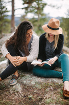 friends reading a Bible outdoors 
