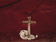 a cross embedded in a wall 