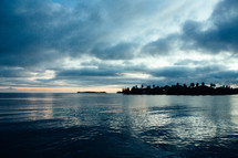 view of calm water and islands at dusk 