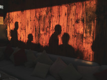shadows of people behind a couch 