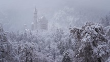falling snow and a castle on a hill 