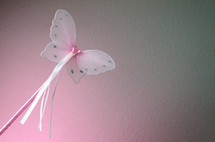 Pink butterfly wand with ribbons and heart shaped jewel head. 