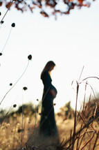 Pregnant woman in field