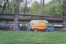 Photograph of a yellow van with scratched effect