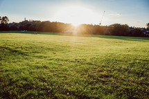 bright sunlight over a green field 