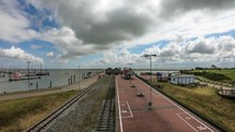Time-lapse at the and of the railway on Langeoog, Germany.  Moving clouds over the train