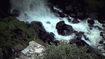 Water rushing over rocks in a stream.