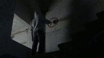 a man using spray paint in an abandoned building 