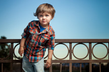 toddler boy on a balcony 