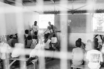 children learning in a school house 