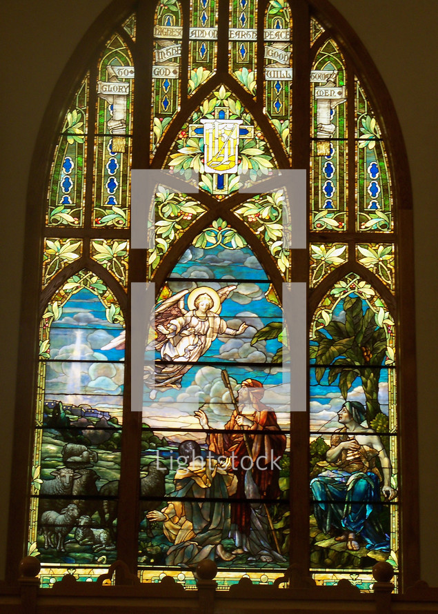 An Angel appears before a group of Shepherds in this stained glass window art depiction of the coming Jesus and announcing HIs birth. 

"And there were shepherds living out in the fields nearby, keeping watch over their flocks at night.  An angel of the Lord appeared to them, and the glory of the Lord shone around them, and they were terrified. But the angel said to them, “Do not be afraid. I bring you good news that will cause great joy for all the people. Today in the town of David a Savior has been born to you; he is the Messiah, the Lord. This will be a sign to you: You will find a baby wrapped in cloths and lying in a manger.” - Luke 2: 8 - 12