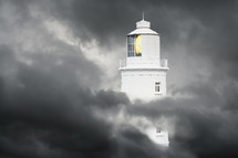 Lighthouse surrounded by storm clouds
