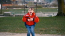 Smiling boy on a swing 