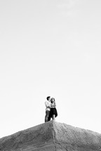 couple in an embrace on a ledge