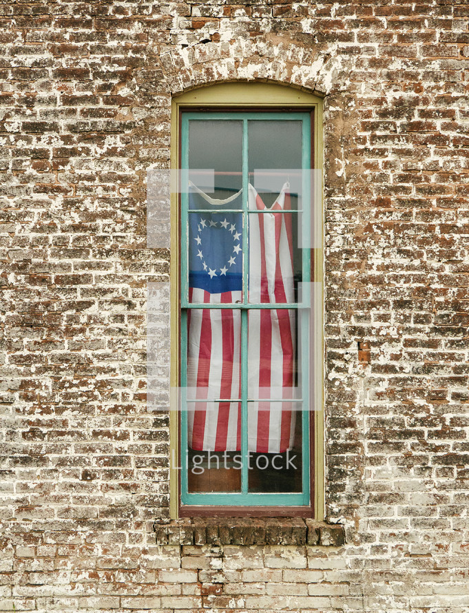 old glory hanging in a window 