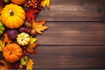 Autumn background with pumpkins, leaves and berries on wooden table