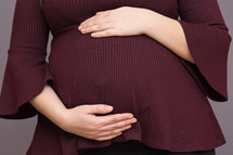 woman holding a pregnant belly 
