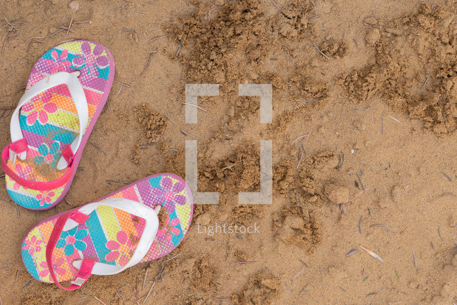 flip flops in sand 