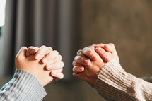 Hands folded together in prayer