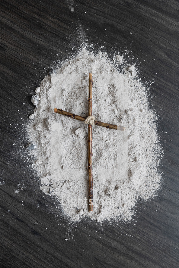 cross of sticks on ashes 