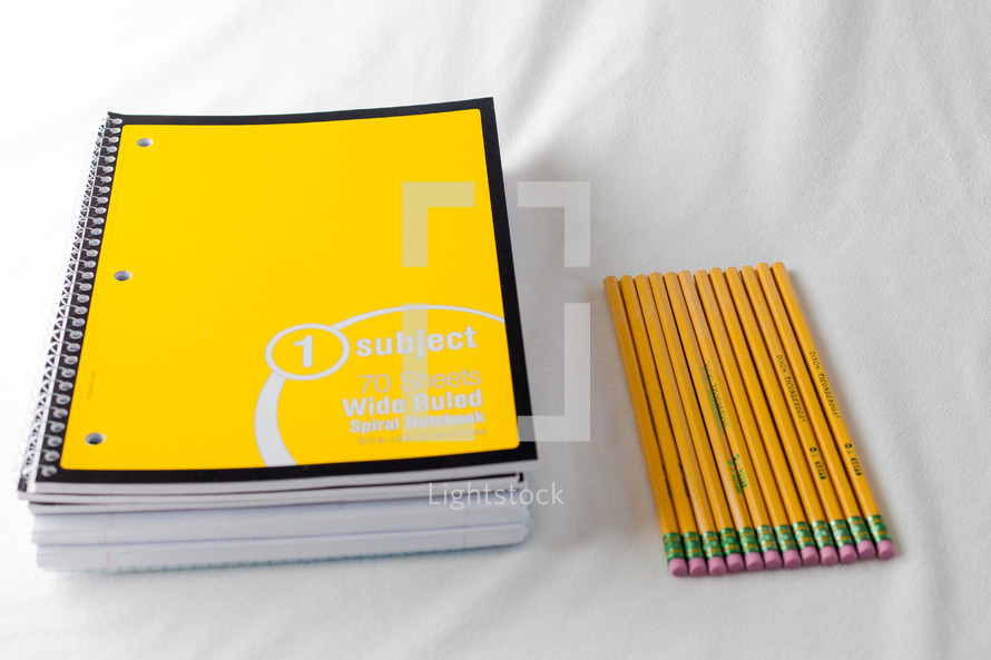 spiral notebooks and pencils 