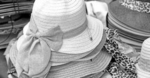 stacks of straw hats at a market 