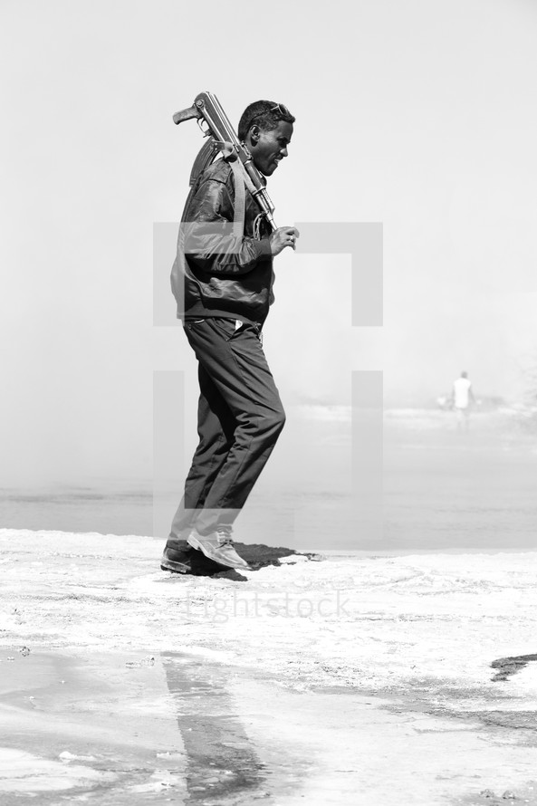 man policing the area near a salt lake in Ethiopia 