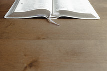 open Bible on a wood background with copy space 