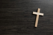 wood cross on a black wood background 