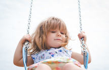 a little girl on a swing 