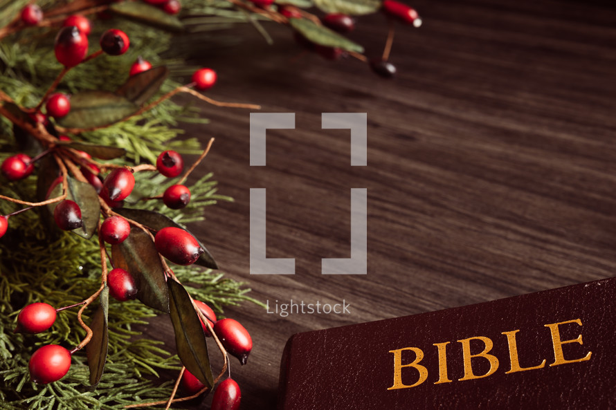 Christmas garland with berries and Bible