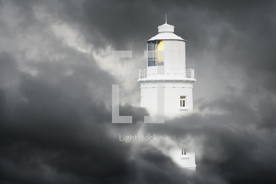 Lighthouse surrounded by storm clouds
