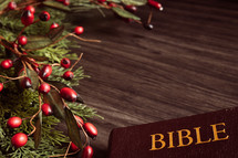 Christmas garland with berries and Bible