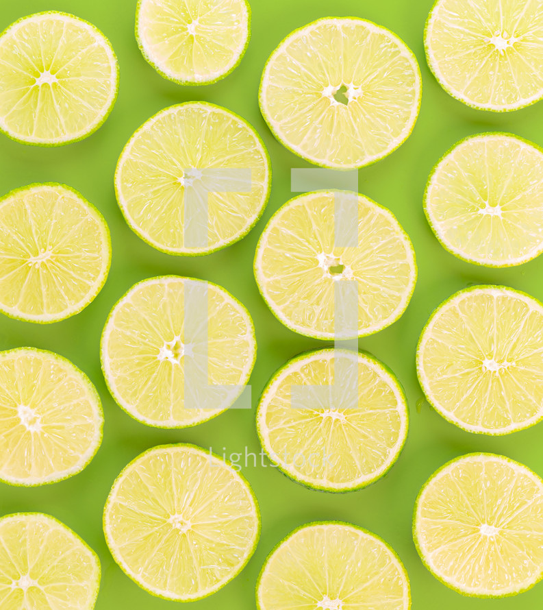 Sliced lemons against a green background