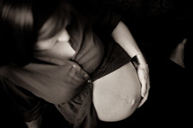 pregnant woman with her hands on her belly