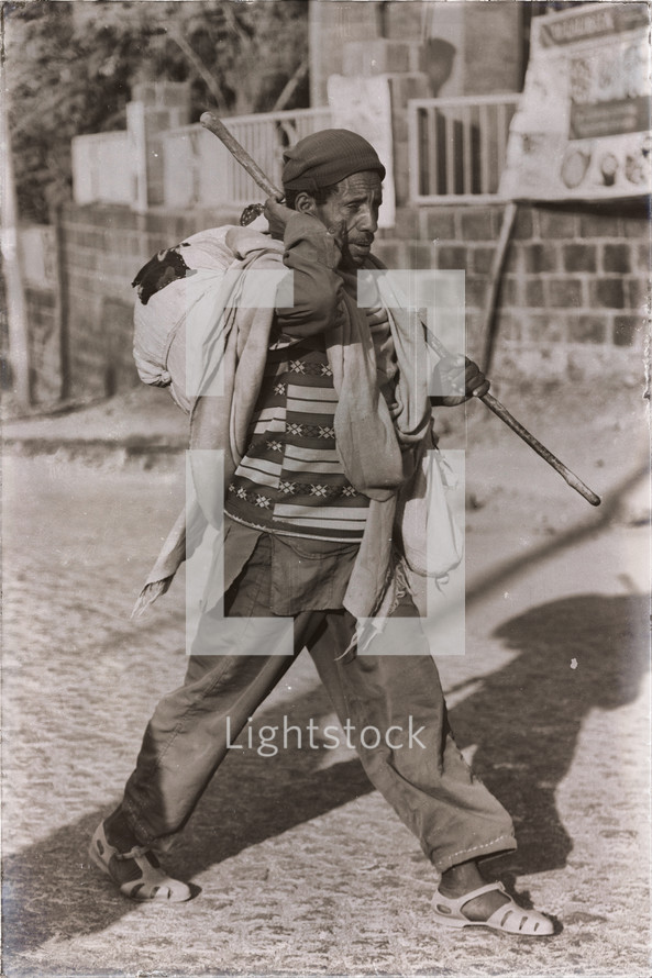 man walking carrying clothes in Ethiopia 