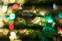 ornament on a Christmas tree and bokeh Christmas lights 