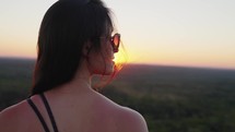Adventurous Woman enjoying beautiful landscape and contemplating vibrant sunset. Taken in Jalapao National Park in Brazil.
