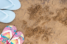 flip flops in sand 
